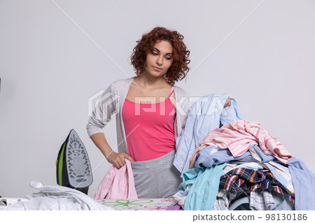 Hard and monotonous work at home while ironing clothes. Hard and monotonous work at home while ironing clothes. 98130186
