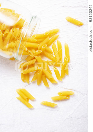 Raw dry Italian pasta in glass bank 98130243