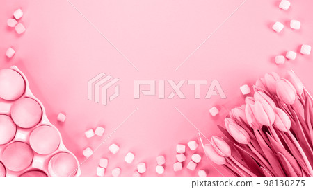 Spring flat lay with fresh tulips colorful eggs. Image is toned in Viva Magenta color of year 2023. Easter, Mother day, birthday or Anniversary with copy-space. Easter eggs, small pastel marshmallows. 98130275