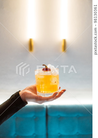 Woman holding caipirinha Brazilian typical drink, cocktail of cachaca Woman holding caipirinha Brazilian typical drink, cocktail of cachaca 98130361