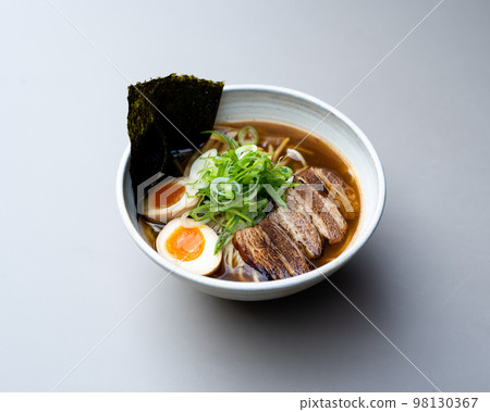 Asian noodle soup, ramen with meat, tofu, vegetables, nori and egg in white bowl Asian noodle soup, ramen with meat, tofu, vegetables, nori and egg in white bowl 98130367