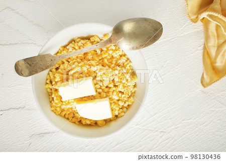 Barley porridge with butter in white bowl 98130436