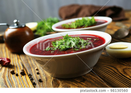 Traditional Ukrainian Russian borscht . Bowl of red beet root soup borsch with white cream . Beet Root delicious soup . Traditional Ukrainian food cuisine Traditional Ukrainian Russian borscht . Bowl of red beet root soup borsch with white cream . Beet Root delicious soup . Traditional Ukrainian food cuisine 98130560