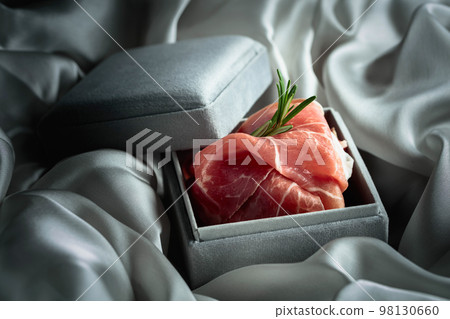 Prosciutto with rosemary in a gray gift box. Prosciutto with rosemary in a gray gift box. 98130660
