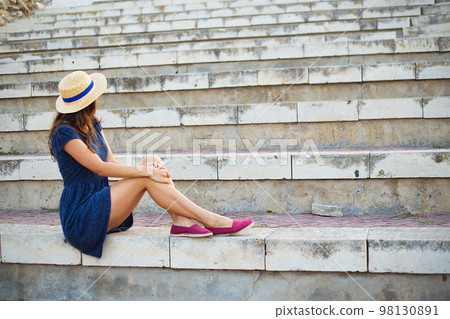 The girl is sitting with her back in the amphitheater. Bulgaria, Nessebar The girl is sitting with her back in the amphitheater. Bulgaria, Nessebar 98130891