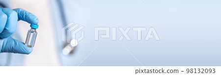 Doctor in blue latex gloves holding glass vial with vaccine. Long banner Doctor in blue latex gloves holding glass vial with vaccine. Long banner 98132093