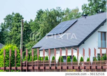 Historic farm house with modern solar panels on roof and wall High quality photo 98132516
