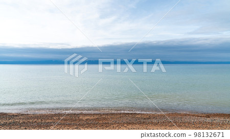 Issyk Kul Lake scenery in Kyrgyzstan. Issyk Kul is a large, high-altitude lake, known for its crystal clear waters and is a popular tourist destination in the region. 98132671