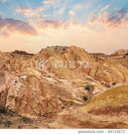 Scenery from Fairytale Canyon, unique rock formation located in Kyrgyzstan. Canyon is known for its unusual and colorful rock formations, which have been shaped over time by wind and water erosion. 98132672