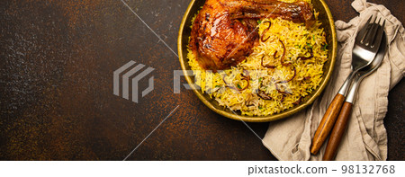 Indian dish Biryani chicken with basmati rice in metal brass old bowl on table Indian dish Biryani chicken with basmati rice in metal brass old bowl on table 98132768