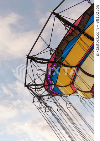 Retro merry go round and cloudy sky in the background 98132858