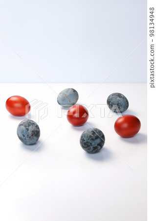 Defocus blue and red eggs on white background. Minimal Easter celebration concept. Design, visual art, minimalism. Balance and harmony concept. Mental health. Pattern. Vertical. Out of focus Defocus blue and red eggs on white background. Minimal Easter celebration concept. Design, visual art, minimalism. Balance and harmony concept. Mental health. Pattern. Vertical. Out of focus 98134948
