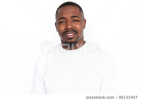 Dissatisfied young man showing irritation Dissatisfied young man showing irritation 98135407