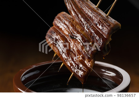 Grilled eel marinated in a secret sauce 98136657