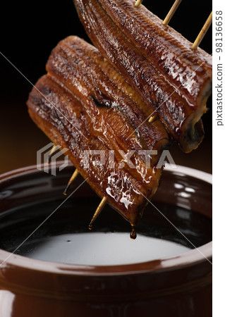 Grilled eel marinated in a secret sauce Grilled eel marinated in a secret sauce 98136658