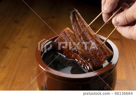 Grilled eel marinated in a secret sauce 98136664