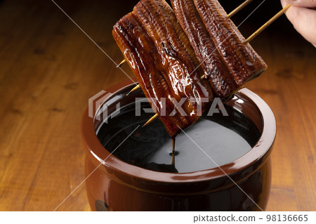 Grilled eel marinated in a secret sauce Grilled eel marinated in a secret sauce 98136665