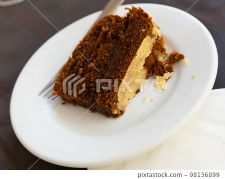 Portion of chocolate orange cake 98136899