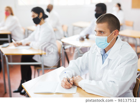 Group of medical academy students in protective masks at lesson 98137512