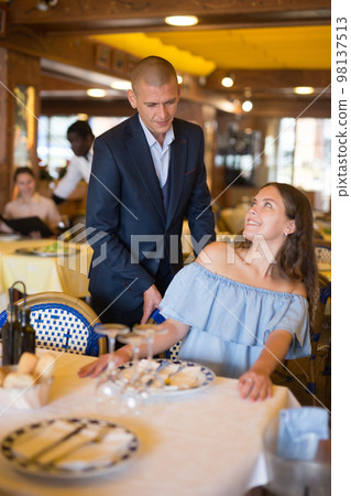 Portrait of a young elegant couple visiting restaurant 98137513