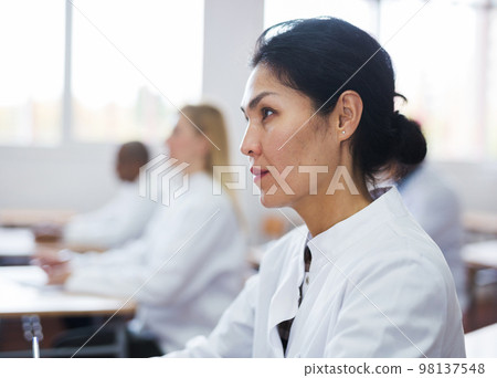 Young woman studying with colleagues medicals 98137548