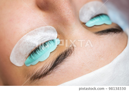 Portrait of a woman in a beauty salon on the procedure of eyelash lamination.  98138330