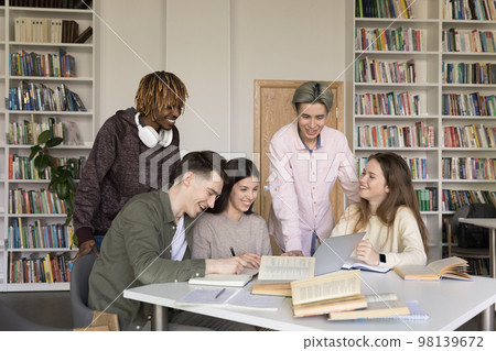 Diverse team of happy college students meeting in university library Diverse team of happy college students meeting in university library 98139672