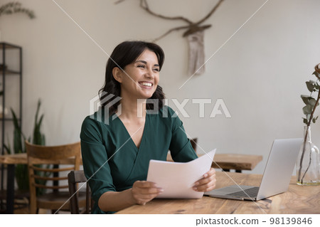 Happy young freelance business woman holding legal documents 98139846