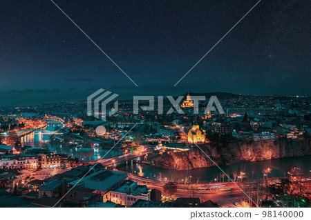 Tbilisi, Georgia. night dusk evening Top View Of Famous Landmarks In spring Evening dusk night. starry sky night sky above Georgian Capital Skyline Cityscape. altered stars sky 98140000