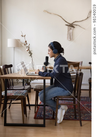 Beautiful Indian radio DJ girl using studio equipment, laptop Beautiful Indian radio DJ girl using studio equipment, laptop 98140019