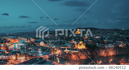 Tbilisi, Georgia. panorama night dusk evening Top View Of Famous Landmarks In spring sunset Evening dusk night. Georgian Capital Skyline Cityscape. Justice House, Bridge Of Peace, Concert Hall, Tbilisi, Georgia. panorama night dusk evening Top View Of Famous Landmarks In spring sunset Evening dusk night. Georgian Capital Skyline Cityscape. Justice House, Bridge Of Peace, Concert Hall, 98140512