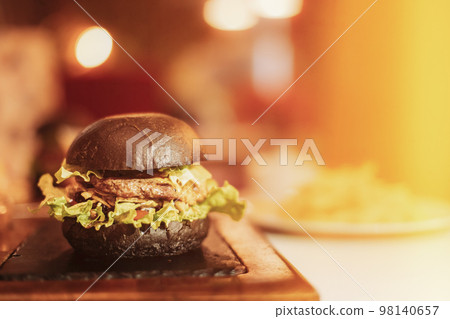 Closeup Of Juicy Burger With Tasty Cutlet And Lettuce Between Soft Roasted Buns In Restaurant. Front View Burger With Veggies And Meat. Juicy Hamburger. Copy Space Closeup Of Juicy Burger With Tasty Cutlet And Lettuce Between Soft Roasted Buns In Restaurant. Front View Burger With Veggies And Meat. Juicy Hamburger. Copy Space 98140657