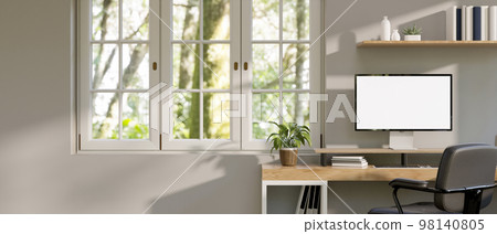 Minimal white home office with computer mockup on wood table, window with nature view Minimal white home office with computer mockup on wood table, window with nature view 98140805