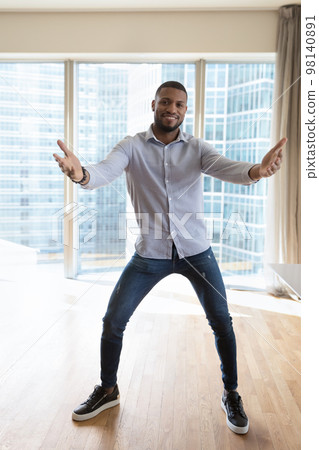 African man moving to music looks at camera African man moving to music looks at camera 98140891