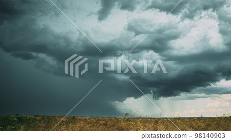 Storm Cloudy Rainy Sky. Dramatic Sky With Dark Clouds In Rainy Day. Storm And Rain Above Summer Field. , , . 4K. Agricultural And Weather Forecast Concept Storm Cloudy Rainy Sky. Dramatic Sky With Dark Clouds In Rainy Day. Storm And Rain Above Summer Field. , , . 4K. Agricultural And Weather Forecast Concept 98140903