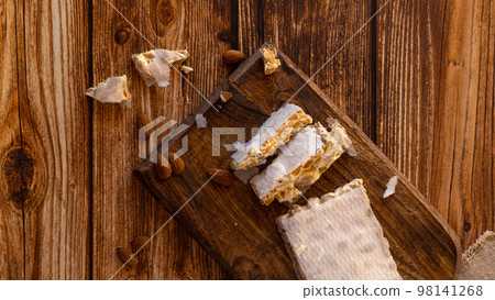 Top view of Almond turron dessert slices on wooden desk Top view of Almond turron dessert slices on wooden desk 98141268