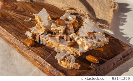 Almond turron dessert slices on wooden desk Almond turron dessert slices on wooden desk 98141269