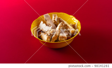 Almond turron dessert in bowl on red background 98141281