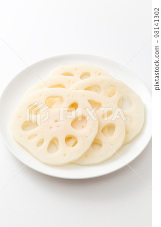 Lotus root sliced on a white plate Lotus root sliced on a white plate 98141302