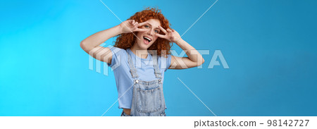 Say cheeze hello summer. Cheerful charming playful charismatic redhead cute girl curly hairstyle show tongue peace victory gesture eyes tilt head joyful mimicking funny attitude happy emotions Say cheeze hello summer. Cheerful charming playful charismatic redhead cute girl curly hairstyle show tongue peace victory gesture eyes tilt head joyful mimicking funny attitude happy emotions 98142727