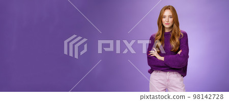 Time manage business. Portrait of confident and ready good-looking redhead female entrepreneur with freckles standing in warm stylish sweater holding hands crossed over chest in assured pose, smiling Time manage business. Portrait of confident and ready good-looking redhead female entrepreneur with freckles standing in warm stylish sweater holding hands crossed over chest in assured pose, smiling 98142728