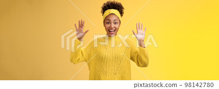 Charming excited smiling friendly millennial african-american girl raise hands nothing hide show palms high surrender standing amused thrilled grinning having fun posing yellow background 98142780