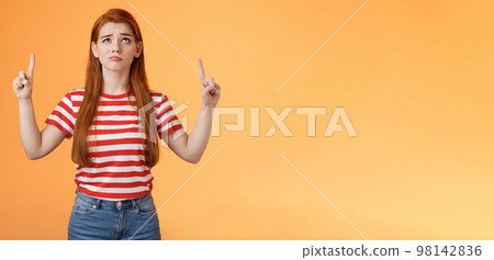 Hesitant upset cute redhead woman weighing choices look doubtful uncertain, frowning thoughtful, ponder decision, look pointing up unsure, have doubts, stand insecure orange background Hesitant upset cute redhead woman weighing choices look doubtful uncertain, frowning thoughtful, ponder decision, look pointing up unsure, have doubts, stand insecure orange background 98142836