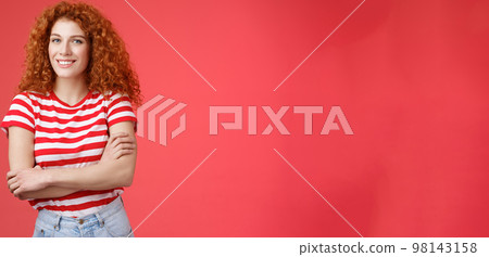 Confident tender silly redhead beautiful curly-haired girl cross arms body smiling broadly delighted amused cheerfully enjoy warm summer evening walks tropical country holiday red background 98143158