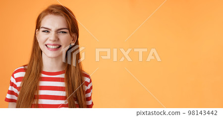 Close-up sassy good-looking cheerful redhead sly girl smiling toothy white perfect grin, satisfied dental clinic professional cleaning, standing orange background happy, joyful summer mood Close-up sassy good-looking cheerful redhead sly girl smiling toothy white perfect grin, satisfied dental clinic professional cleaning, standing orange background happy, joyful summer mood 98143442