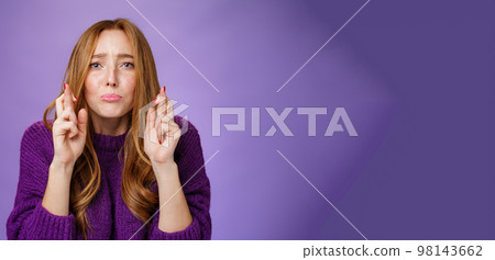 Close-up shot of sorrow and uneasy cute redhead woman being troubled pouting gloomy and crossing fingers for good luck hopeful, praying for misfortune gone away, begging god for mercy 98143662