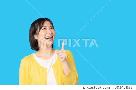 A woman pointing up 98143952