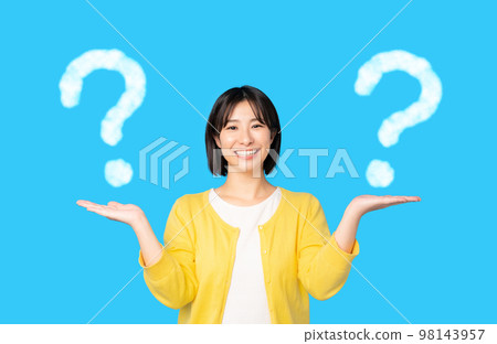 woman comparing two things woman comparing two things 98143957