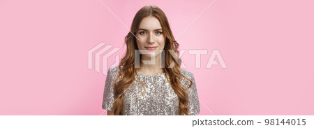 Close-up confident determined attractive stylish woman evening makeup curly hairstyle wearing party outfit smiling self-assured, dress-up evening dance club, standing happily pink background 98144015