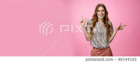 Pretty confident carefree caucasian woman enjoying party pointing sideways different sides smiling unbothered happy show you choices, opportunities, make decision standing pink background 98144183